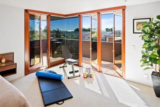 a bedroom with furniture and a large window