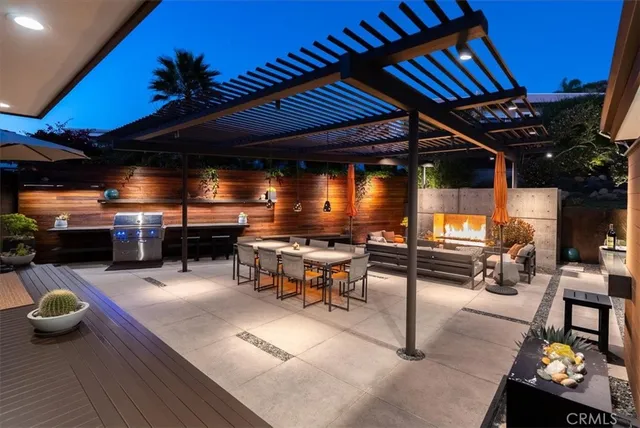 a view of a patio with table and chairs and potted plants