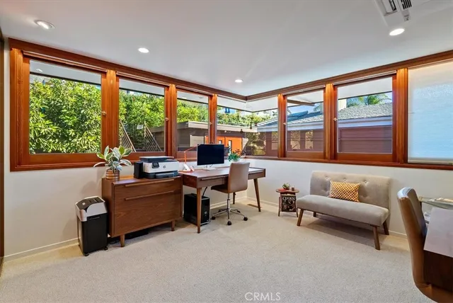 a vase of flowers sitting on a table with potted plant