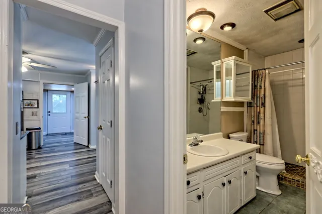 a bedroom with a bed and ceiling fan