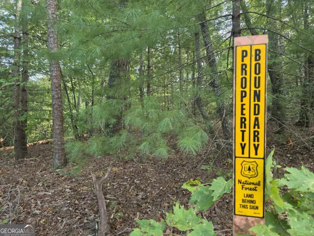 a view of a house with swimming pool and sitting area