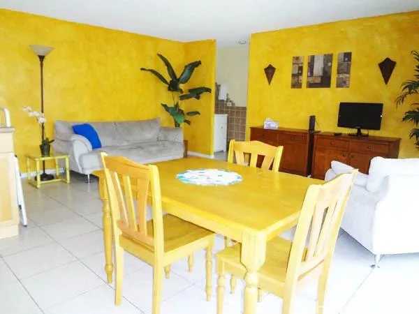 a view of a dining room with furniture and a flat screen tv