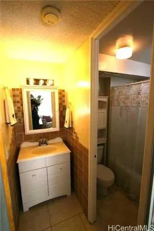 a bathroom with a toilet sink and shower