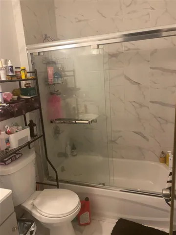 a bathroom with a toilet and a shower
