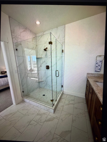 952 East Shilow Road, Unit 131 Erda, UT 84074 - Photo 10 of 12 Glass-enclosed shower with full-height marble-look tile surround and built-in bench