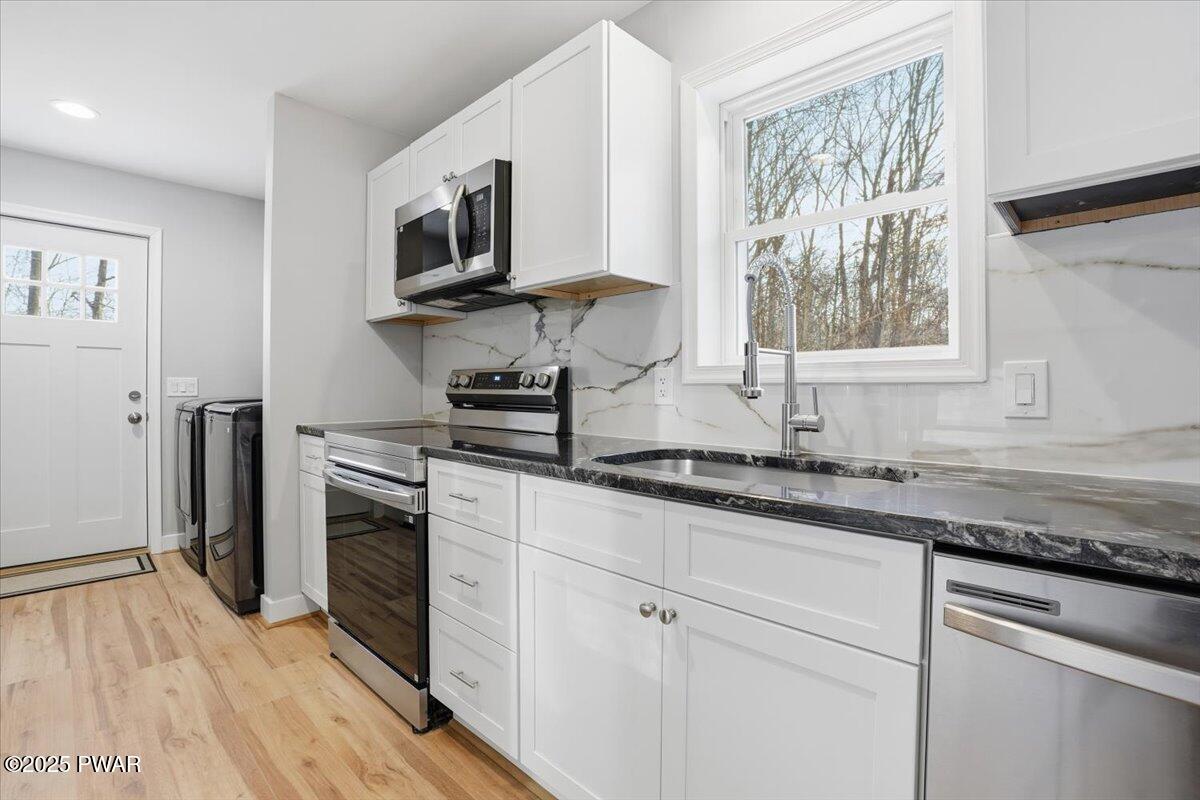 10 Swingle Road Moscow, PA 18444 - Photo 23 of 60 a kitchen with granite countertop a sink wooden floor and stainless steel appliances