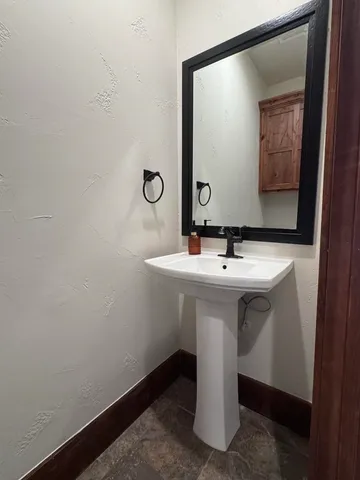 a bathroom with a sink and mirror