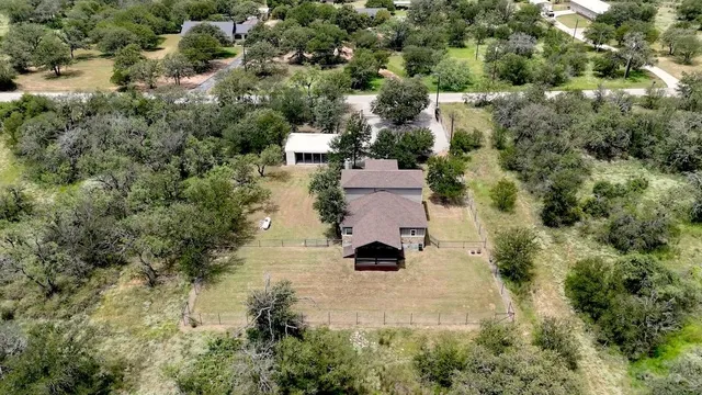 an aerial view of a house with yard
