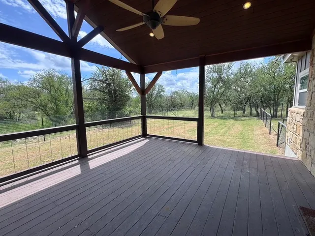 a view of empty room with wooden floor and outdoor space