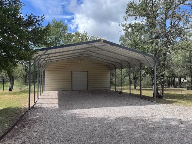 a view of a house with a yard and tree s
