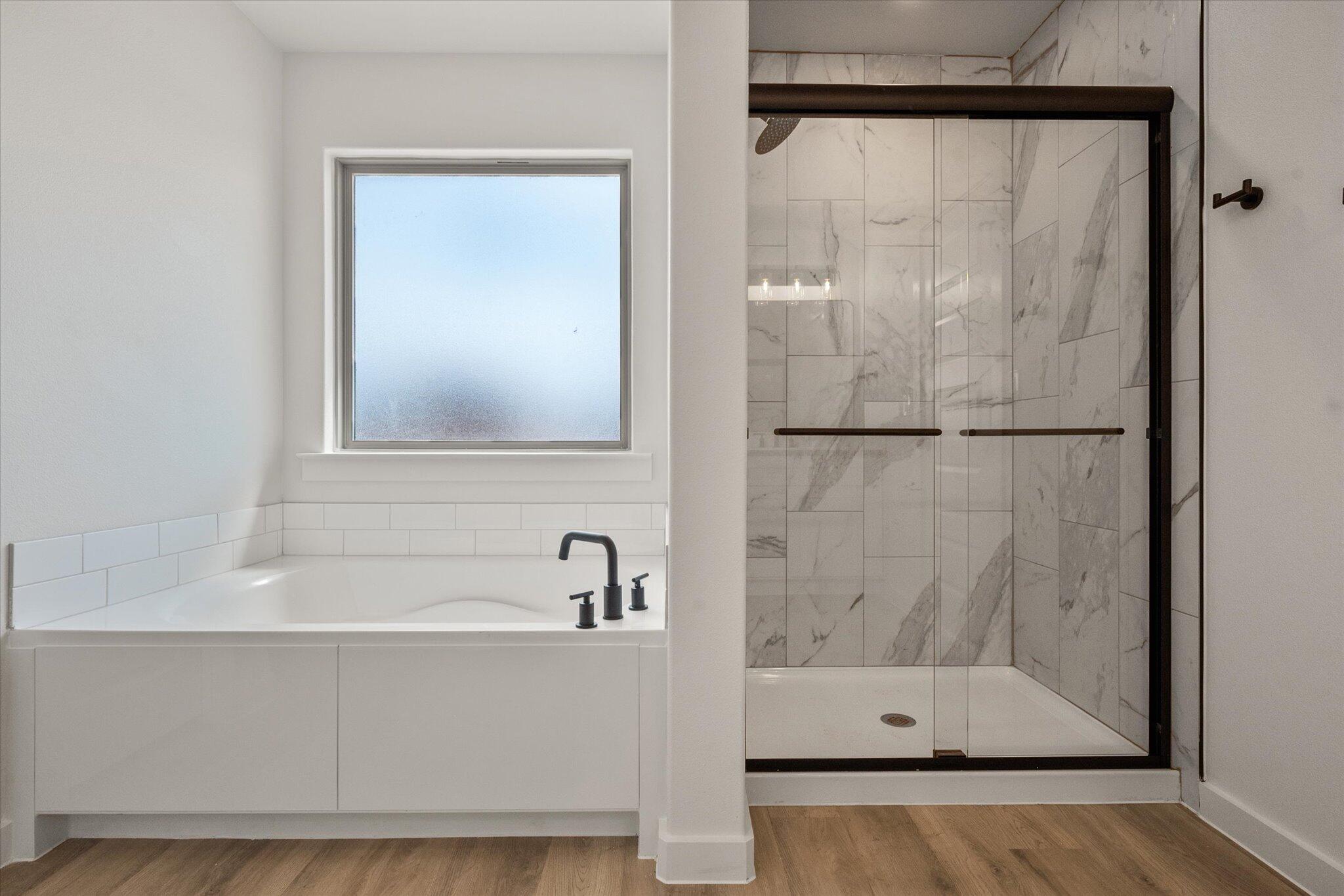 313 East 23rd Street Wolfforth, TX 79382 - Photo 16 of 22 a bathroom with a bathtub and a shower