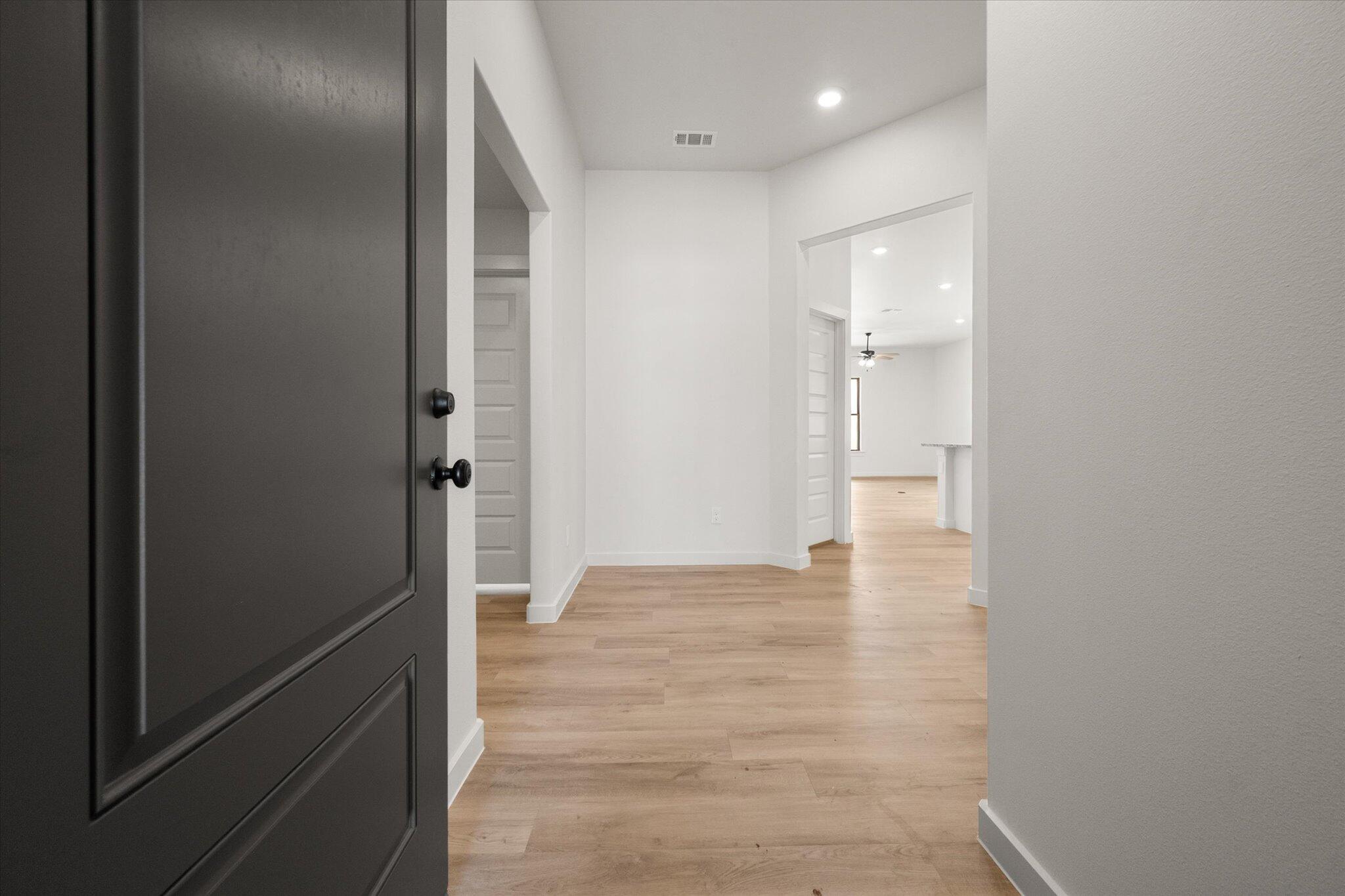 313 East 23rd Street Wolfforth, TX 79382 - Photo 2 of 22 a view of a hallway with wooden floor