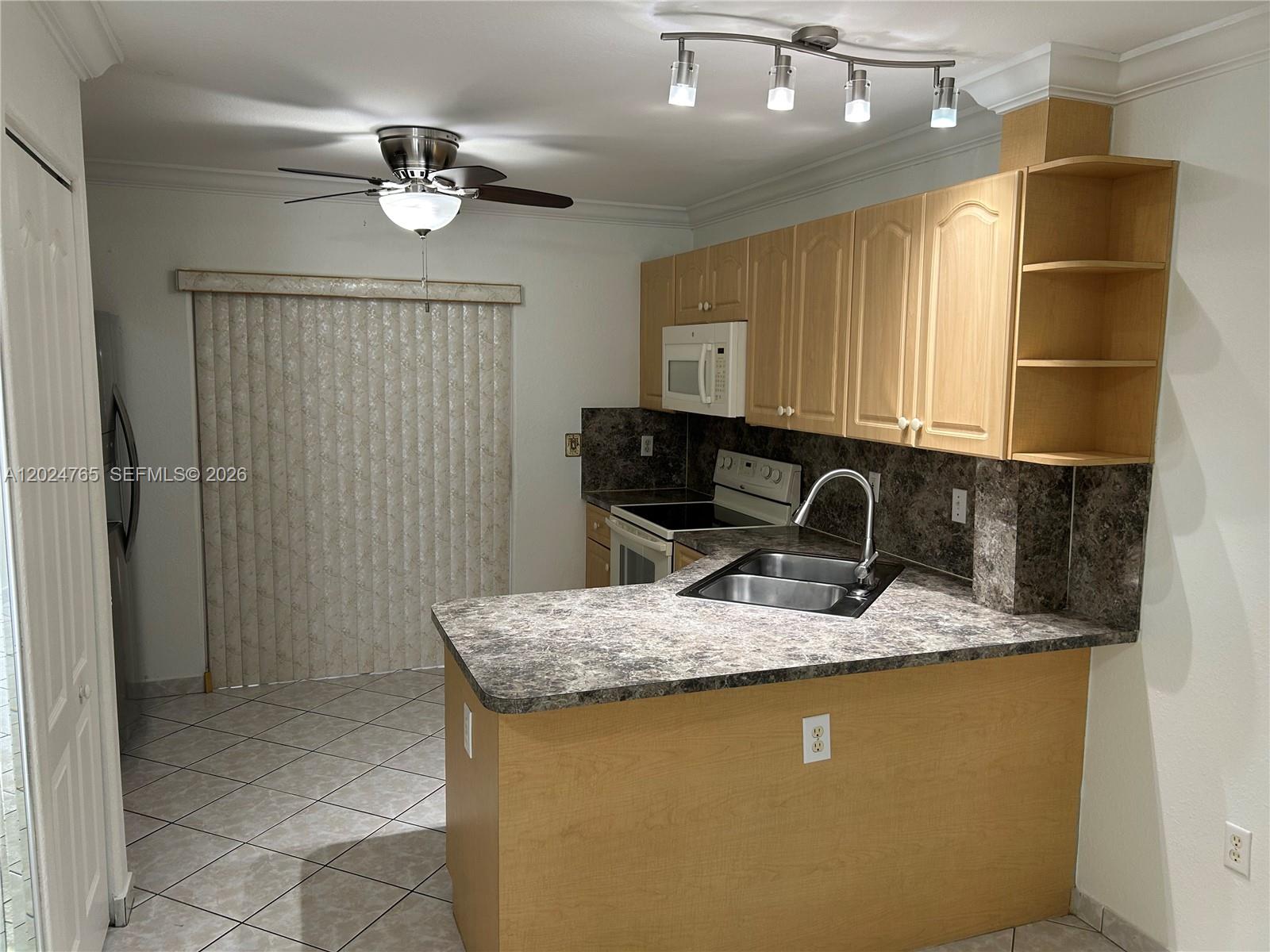 10919 West Okeechobee Road, Unit 101 Hialeah Gardens, FL 33018 - Photo 5 of 21 a bathroom with a granite countertop sink a toilet and mirror