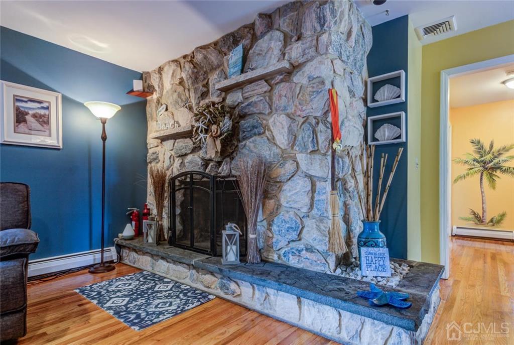 582 Holmdel Road Hazlet, NJ 07730 - Photo 15 of 25 a living room with fireplace furniture and a rug