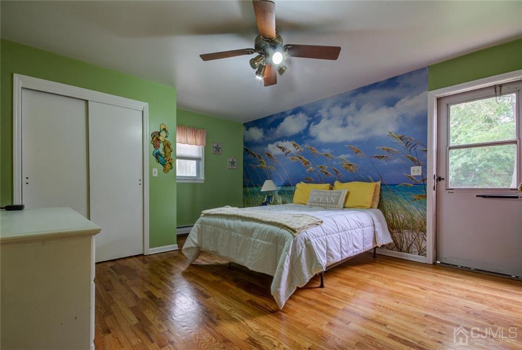 582 Holmdel Road Hazlet, NJ 07730 - Photo 21 of 25 a bedroom with a bed and a chandelier