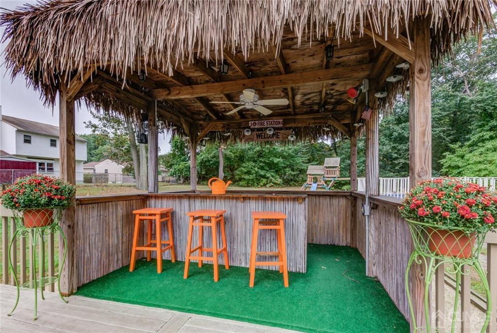 582 Holmdel Road Hazlet, NJ 07730 - Photo 23 of 25 a view of a porch with a table and a chairs with plants