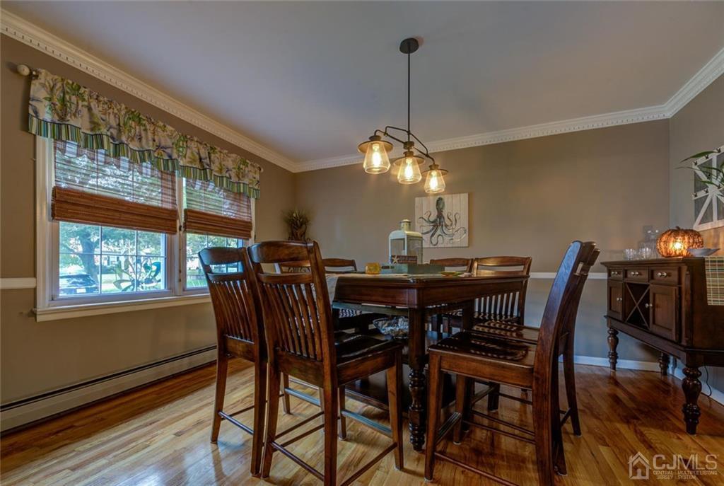 582 Holmdel Road Hazlet, NJ 07730 - Photo 7 of 25 a view of a dining room with furniture window and wooden floor