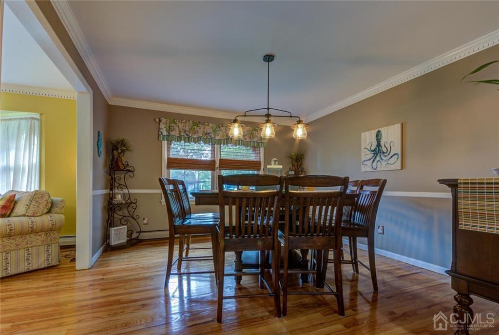 582 Holmdel Road Hazlet, NJ 07730 - Photo 8 of 25 a view of a dining room with furniture window and wooden floor