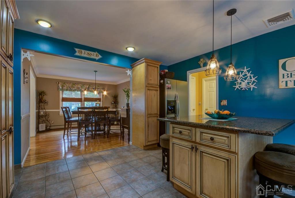 582 Holmdel Road Hazlet, NJ 07730 - Photo 10 of 25 a kitchen with stainless steel appliances granite countertop a sink a stove and a refrigerator
