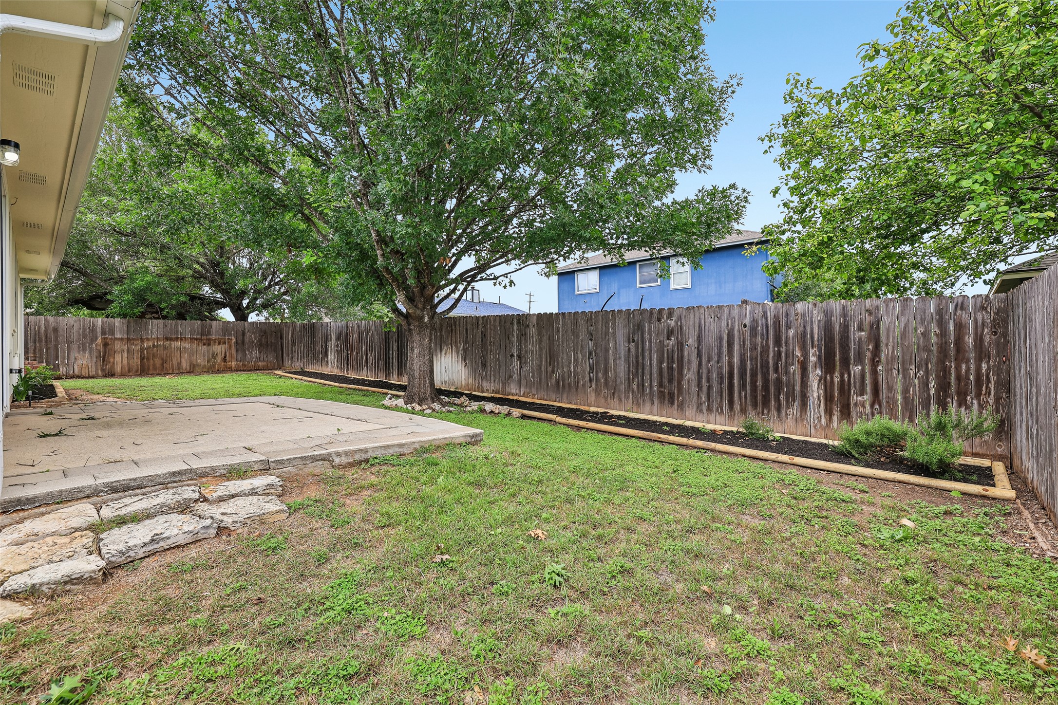 152 Grant Way Kyle, TX 78640 - Photo 39 of 39 a view of a backyard with large trees and wooden fence