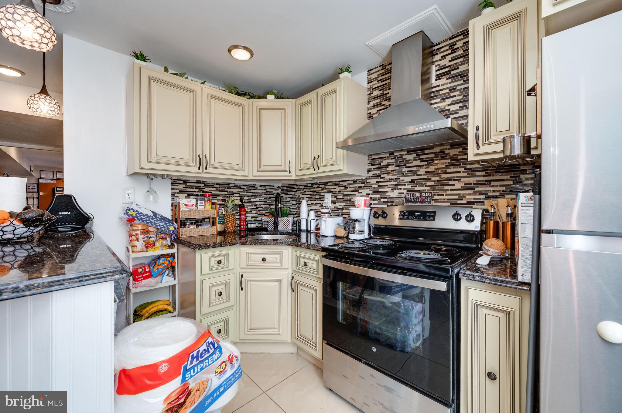 1005 Landover Drive Reading, PA 19605 - Photo 12 of 46 a kitchen with stainless steel appliances granite countertop a stove and a sink