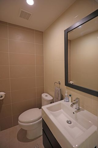 a bathroom with a sink a toilet and mirror