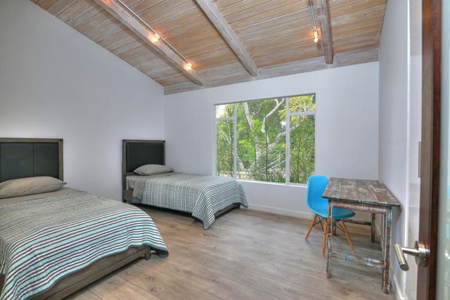 a bedroom with furniture and a window