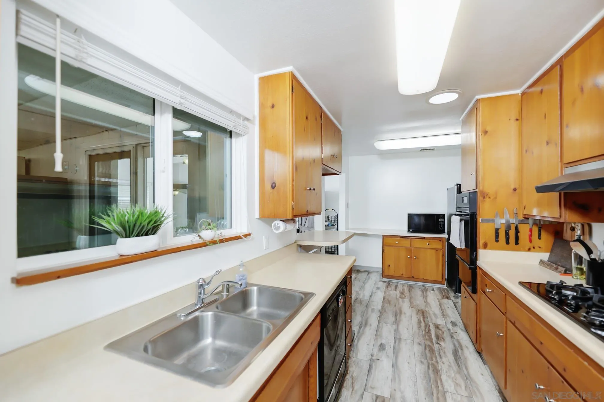 13134 Acton Avenue Poway, CA 92064 - Photo 22 of 37 a kitchen with a sink stove and cabinets