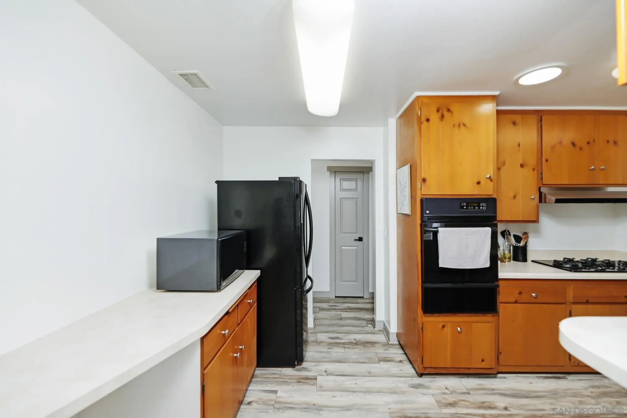 13134 Acton Avenue Poway, CA 92064 - Photo 26 of 37 a kitchen with stainless steel appliances a stove refrigerator and microwave