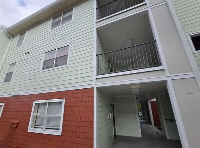 a tree in front of a white house