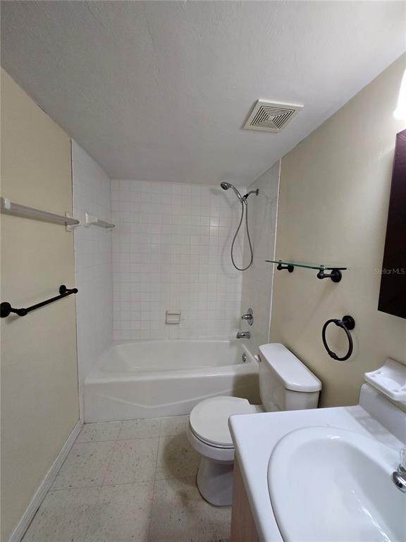 2360 Southwest Archer Road, Unit 604 Gainesville, FL 32608 - Photo 14 of 16 a bathroom with a toilet sink and shower