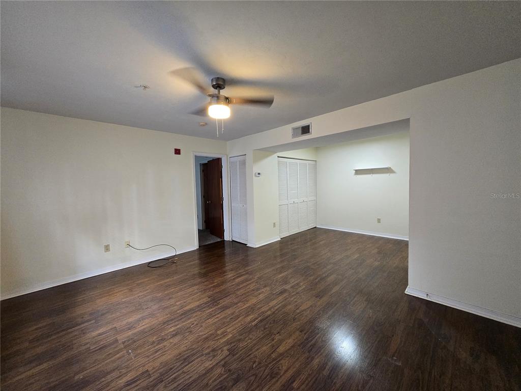 2360 Southwest Archer Road, Unit 604 Gainesville, FL 32608 - Photo 4 of 16 a view of empty room with wooden floor