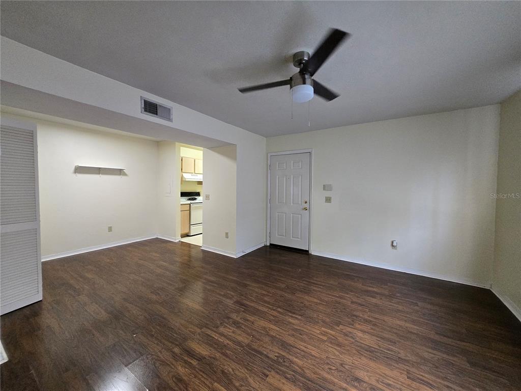 2360 Southwest Archer Road, Unit 604 Gainesville, FL 32608 - Photo 7 of 16 an empty room with wooden floor cabinet and windows