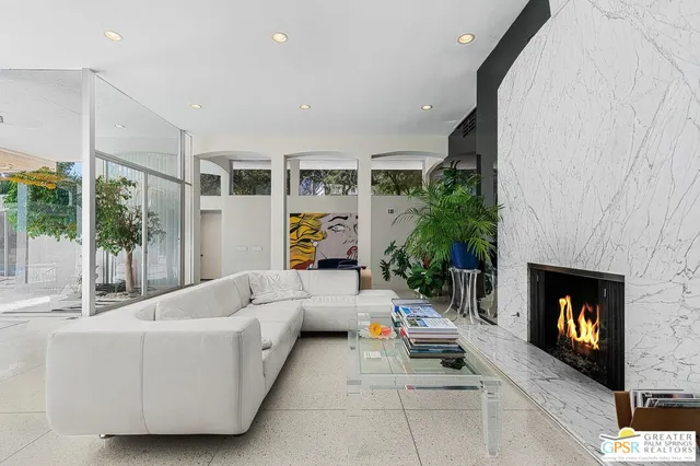 a dining room filled chandelier and wooden floor