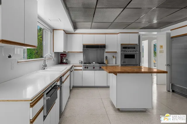 a bedroom with a large bed and a flat tv screen