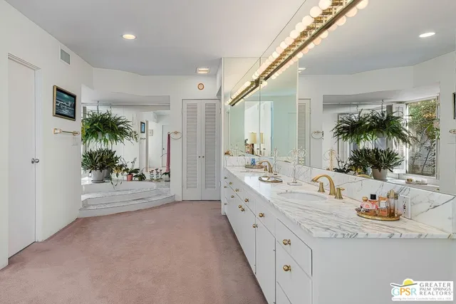 a bedroom with a bed and a television