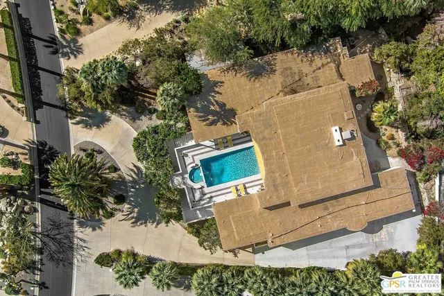 a view of a backyard with plants and a patio
