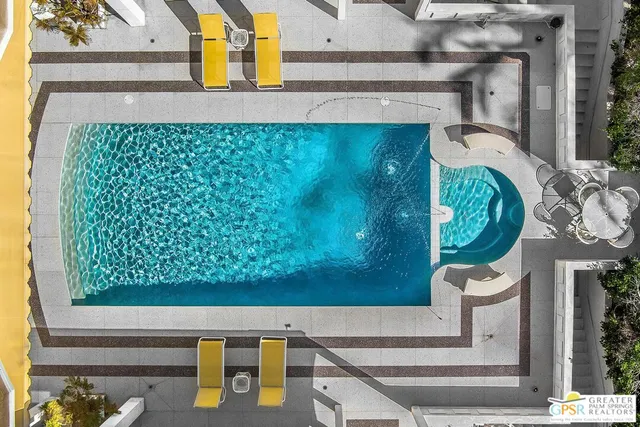 a living room with furniture and large windows