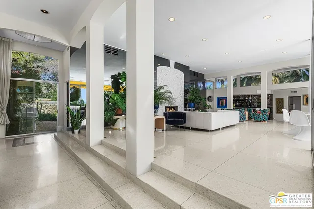 a kitchen with stainless steel appliances kitchen island granite countertop a table and chairs in it
