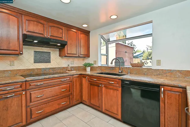 a kitchen with granite countertop stainless steel appliances and sink