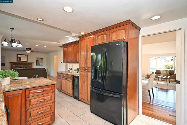 a kitchen with stainless steel appliances granite countertop a refrigerator and a sink