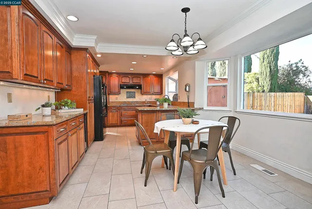 a large kitchen with a table and chairs