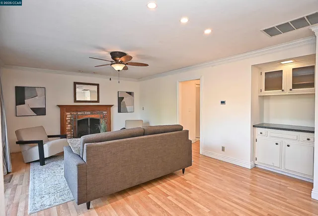 a living room with furniture a fireplace and a flat screen tv