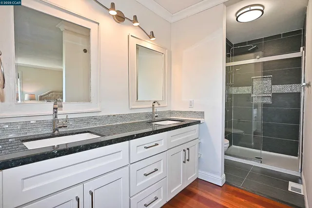 a bathroom with a granite countertop sink mirror and bathtub