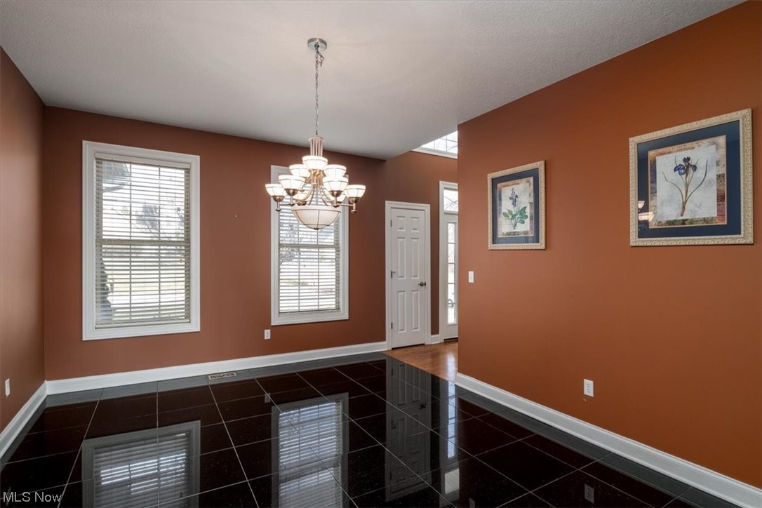 514 Silver Ridge Drive Akron, OH 44321 - Photo 15 of 47 The dining room is off the foyer with a nice chandelier and beautiful granite flooring.