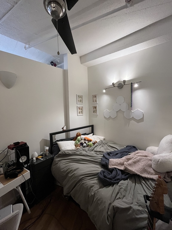 12 Stoneholm Street, Unit 322 Boston, MA 02115 - Photo 12 of 33 a bedroom with a bed and a table