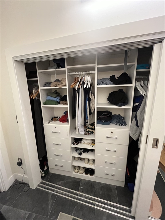 12 Stoneholm Street, Unit 322 Boston, MA 02115 - Photo 14 of 33 a view of walk in closet with clothes and shoes
