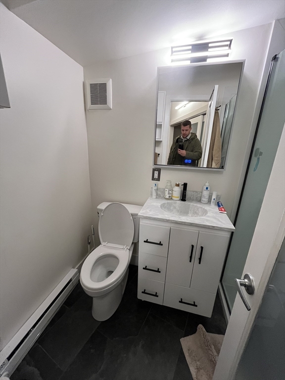 12 Stoneholm Street, Unit 322 Boston, MA 02115 - Photo 19 of 33 a bathroom with a toilet sink and mirror