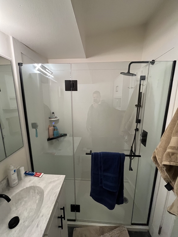 12 Stoneholm Street, Unit 322 Boston, MA 02115 - Photo 20 of 33 a bathroom with a sink and a mirror