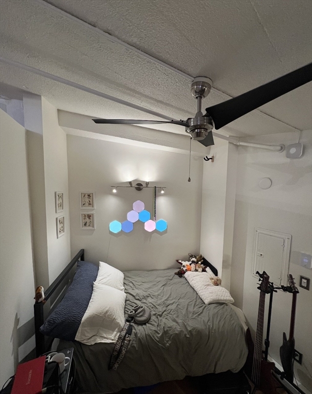 12 Stoneholm Street, Unit 322 Boston, MA 02115 - Photo 2 of 33 a bed sitting in a bedroom next to a window and a lamp